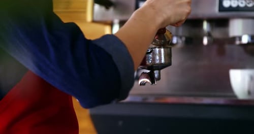 Barista Preparing Espresso with Portafilter and Tamper