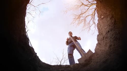 A Man Digs a Grave