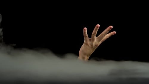 Hand Emerging From Fog on Black Background