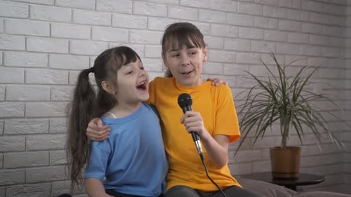 Happy Girls Singing Karaoke Together Indoors