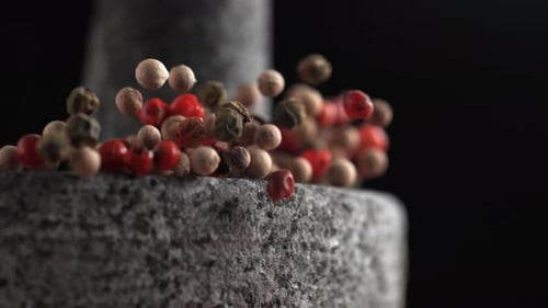 Multi Colored Peppercorns Falling in Slow Motion