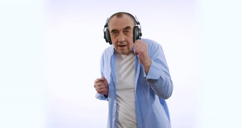 Ralenti d'un homme heureux dans un casque sans fil dansant en profitant de la musique. Appareils modernes