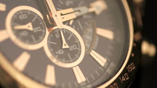 Close Up of Time Passing on a Gold Watch