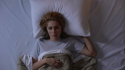 Angry Girl Closing Ears With Pillow, Noisy Neighbors Disturbing Sleep at Night
