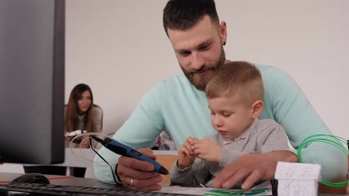 Happy Father Draws with a 3d Pen with a Young Son in a Robotics School
