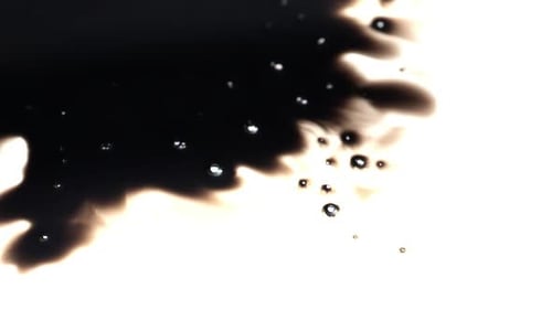Black Ink Drop Spreads on White Surface