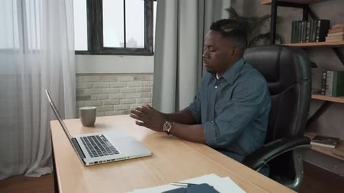 Man Sanitizes Hands and Types at Desk