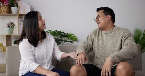 Couple Talking on Couch During Daytime