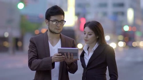 Business Discussion on a City Street at Night