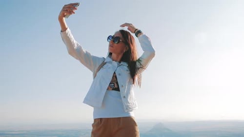 Woman Taking Selfie at Scenic Overlook, Sunny Day