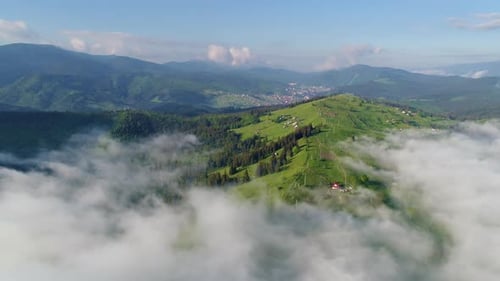 Aerial View of Green Hills and Clouds
