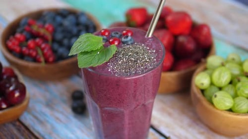 Delicious purple smoothie with fresh berries close-up