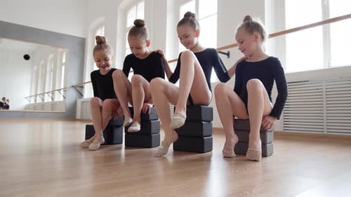 Happy Girls Relaxing in Dance Studio