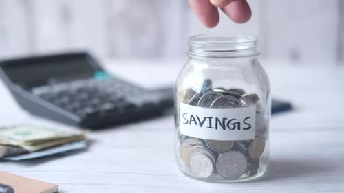 Saving Money Coins in Jar For Future Investment