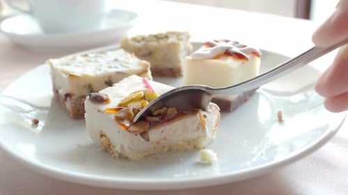 Eating Cake with a Spoon on White Plate