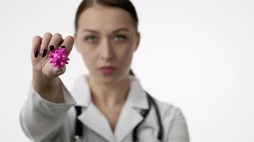 Doctor Holds Virus Model and 'STOP' Sign