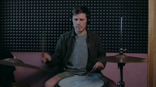 Man Sits Down to Play the Drum Set