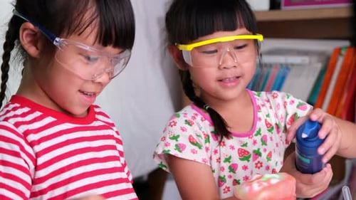 Excited Girls Doing Science Experiment at Home