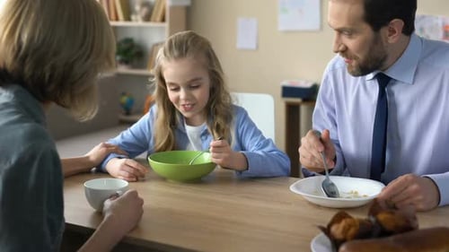 Family Enjoys Breakfast Together at the Table