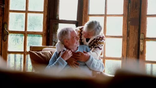Senior Couple Embracing Affectionately Indoors