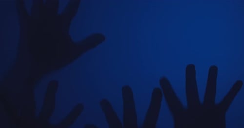 Shadowy Hands Reach Up Against Blue Background