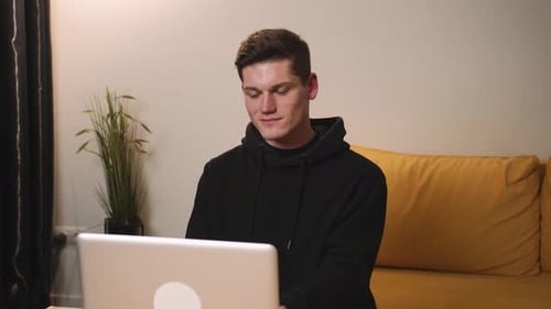 Young Adult Working On Laptop At Home
