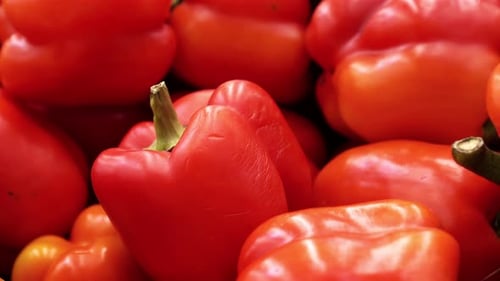 A Lot of Red Pepper Closeup Spinning on a Background in the Store for Buyer.