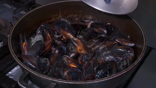 Mussels Being Cooked in a Metal Pan