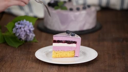 Fork Takes Delicious Slice of Blueberry Cake