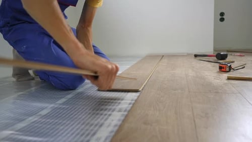 A Man Professional Laminate Installer Laying Laminate Wood