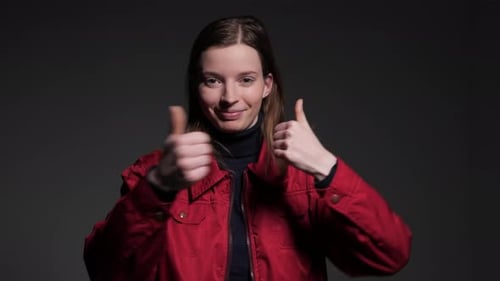 Enthusiastic Woman Gives Thumbs Up in Studio