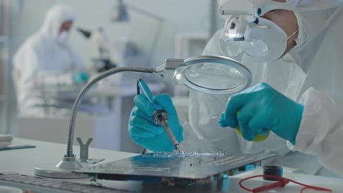 Scientist Repairing Circuit Board in Clean Lab