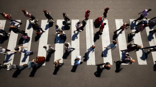 Overhead View of People Walking Across a City Crosswalk