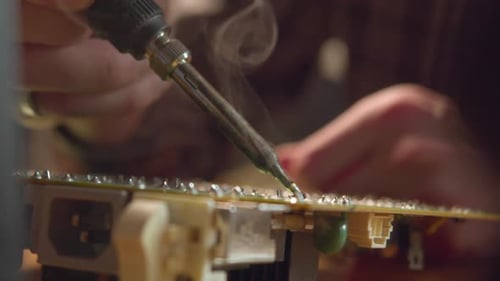 Soldering Iron Repairing a Circuit Board Close Up