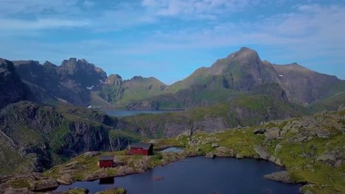 A Flight Over A Lake And A Small House In The Beautiful Mountains Of The Lofoten Islands