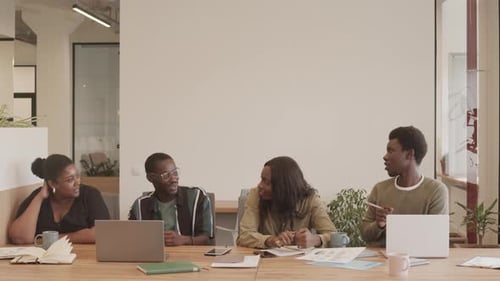 Young People Chatting Together in Office