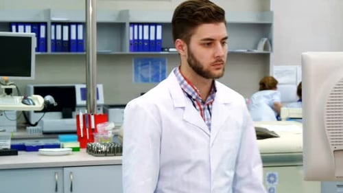 Young Adult Man Working at Computer in Lab