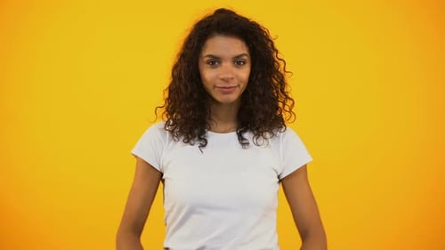 Woman Meditating Against Yellow Background