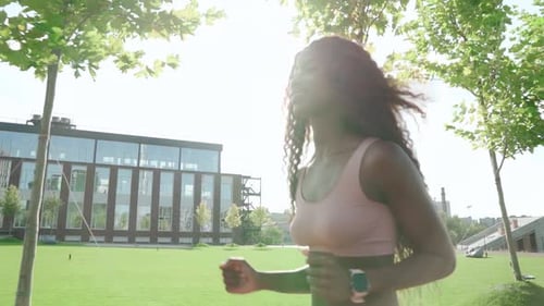 Young Happy Fit Sporty Active Black Woman Running in City Park Outdoors