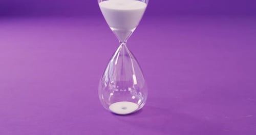 Sandglass against purple background