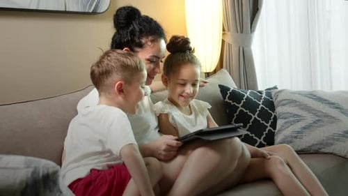 Mother and Children Watching Tablet Together at Home
