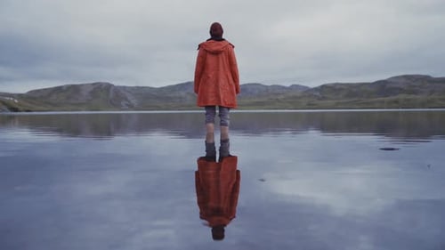 Anonymous traveler in tranquil cold water