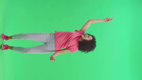 Woman Dancing Enthusiastically on Green Screen Background
