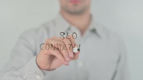 Man Writes SEO Consulting on Clear Surface