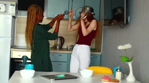 Two Friends Have Fun with Kitchen Utensils