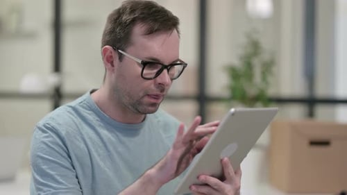 Man Using Tablet in Workplace