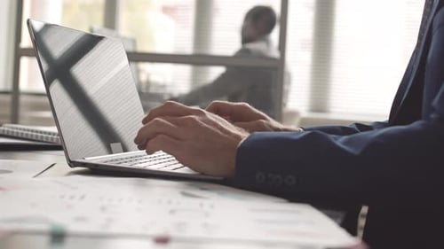 Manager Typing on Computer