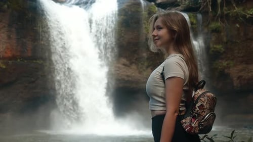Beautiful Young Travel Woman Standing in Front of Waterfall Enjoy Nature