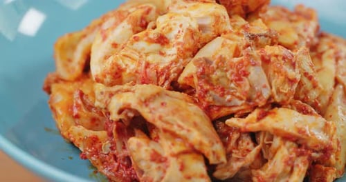 Close-up of Marinated Chicken Chunks in Blue Bowl