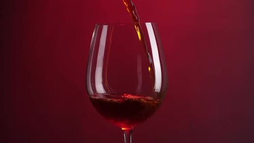 Red Wine Being Poured into Glass